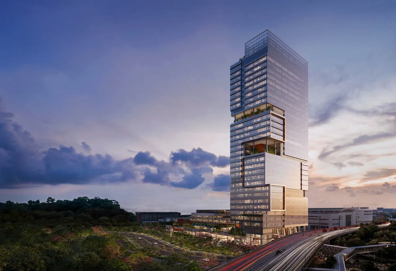 Labrador Tower, a modern glass skyscraper with tiered sections surrounded by greenery and highways at dusk.