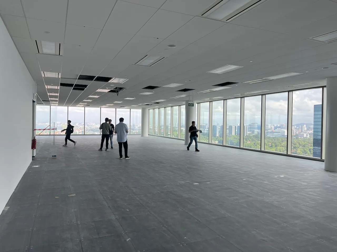 Spacious empty office interior at Labrador Tower with floor-to-ceiling windows overlooking a cityscape